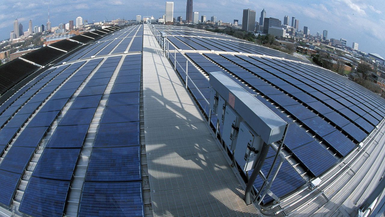 Solar panels on the Georgia Tech Aquatic Center, with Atlanta skyline in the distance