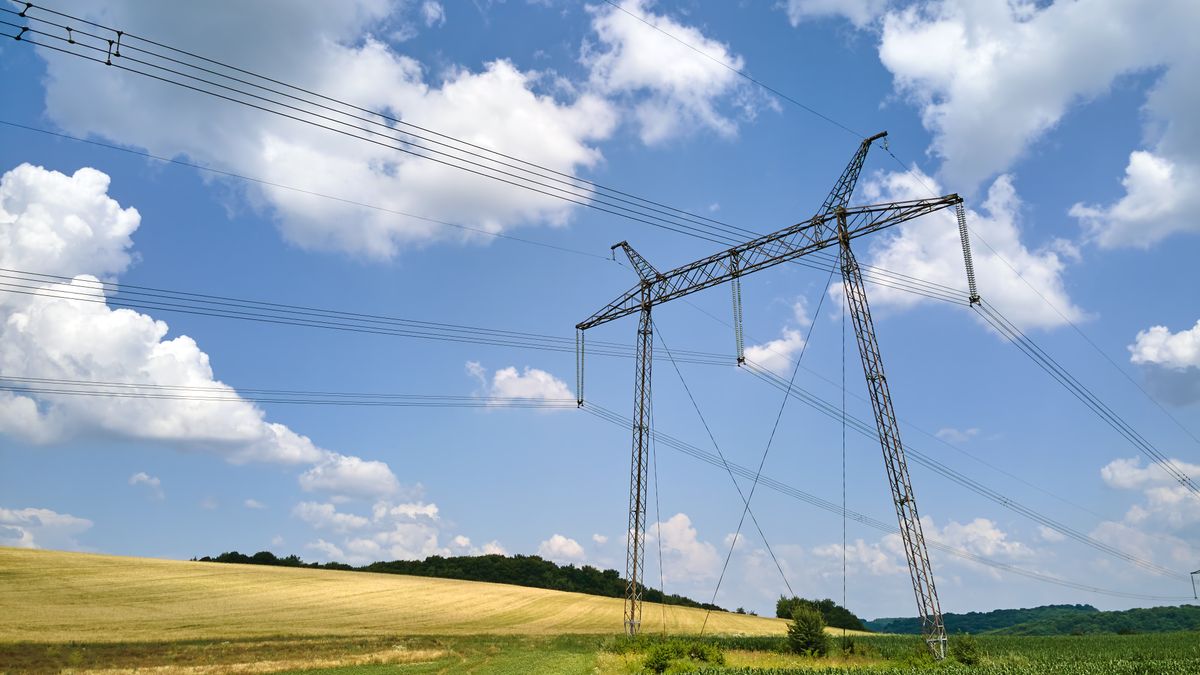 High voltage transmission lines between agricultural fields.